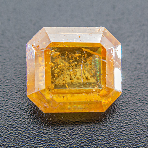 Wulfenite from Namibia. 5.13 Carat. Emerald Cut, very, very distinct inclusions