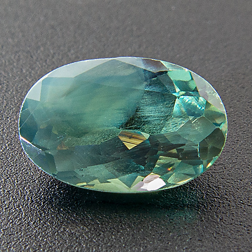 Alexandrite from India. 0.88 Carat. To the unaided eye the cloudiness is not nearly as distinct as on the enlarged Photos. In fact it hardly distracts from the overall beauty of this gem. Good colour change!