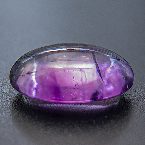 Amethyst from Zambia. 14.78 Carat. On the dark background this amethyst appears darker than is actually is. Also, this gem is distinctly colour zoned.