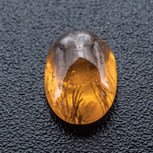 Mandarin Garnet from Namibia. 0.62 Carat. Cabochon Oval, very, very distinct inclusions