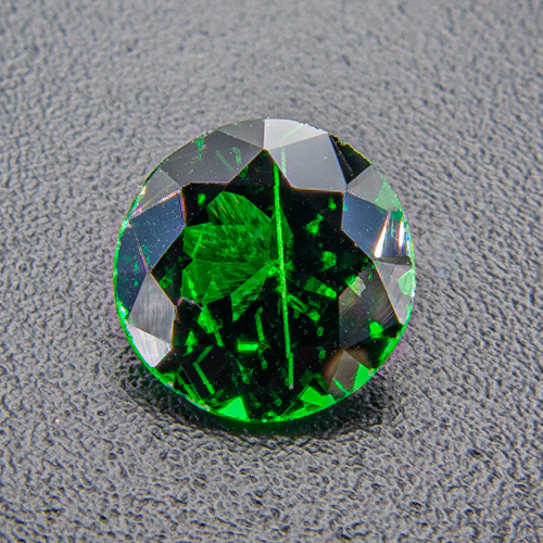 Tsavorite Garnet from Tanzania. 0.69 Carat. The tube-like inclusion is not nearly as prominent to the naked eye as it is on the strongly enlarged photo!