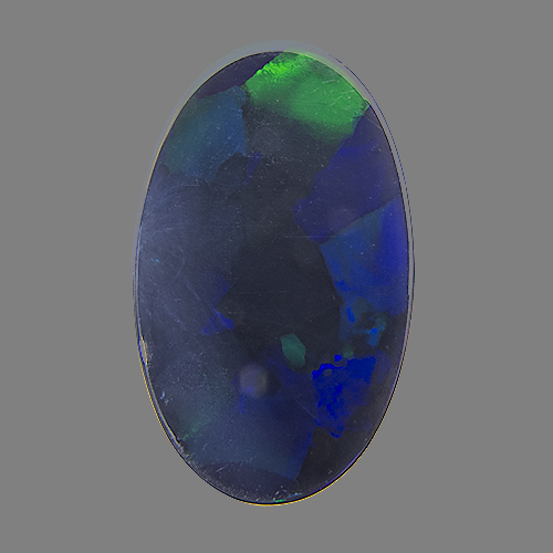 Black Opal from Australia. 4.33 Carat. with several bright green spots flashing up in turns upon moving the stone