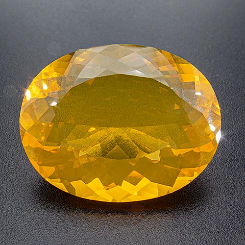 Fire Opal from Brazil. 18.51 Carat. Shows almost none of the milkyness otherwise quite typical for Brazilian fire opal.
The high content of water (up to 20%!) in opal may cause problems.
When opal gives off its water this can lead to haziness or the development of cracks.
We bought this gem in 2015 and kept it try, so nothing of this should happen.