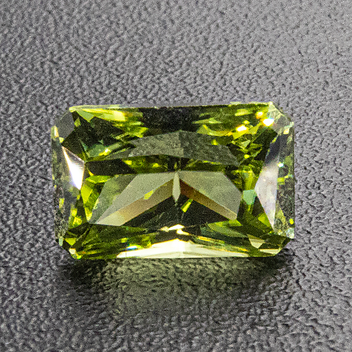 Peridot. 0.55 Carat. Minute chips at crown facet edges