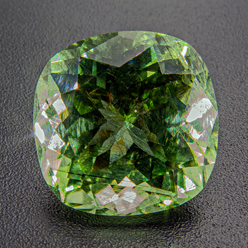 Peridot from Pakistan. 6.62 Carat. Shows fine hairlike ludwigite needles, typical for Pakistani peridot. Excellently cut and vivid stone