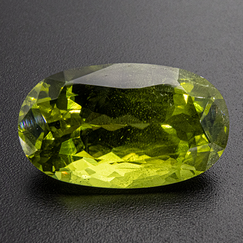 Peridot from Pakistan. 11.59 Carat. Oval, small inclusions