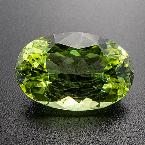 Peridot from Pakistan. 6.1 Carat. Concave Oval, distinct inclusions