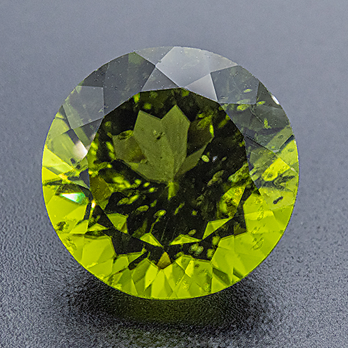 Peridot from China. 12.34 Piece. Round, small inclusions