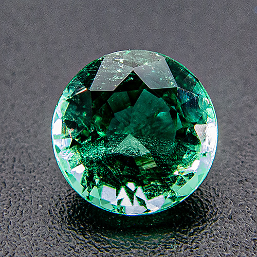 Emerald from Zambia. 0.78 Carat. Round, distinct inclusions