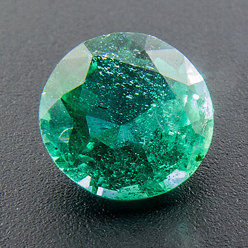 Emerald from Zambia. 0.49 Carat. Round, distinct inclusions