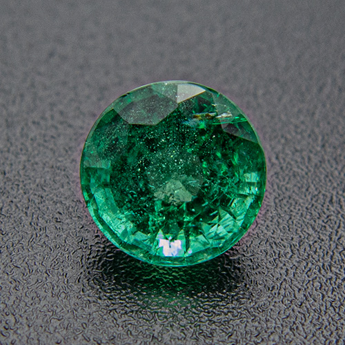 Emerald from Zambia. 0.67 Carat. Round, distinct inclusions