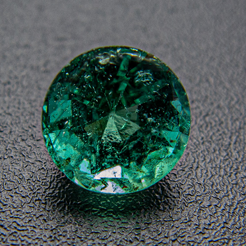 Emerald from Zambia. 0.71 Carat. Round, distinct inclusions