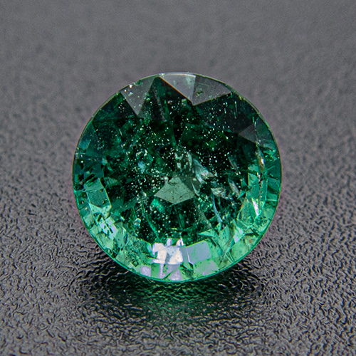 Emerald from Zambia. 0.73 Carat. Round, distinct inclusions