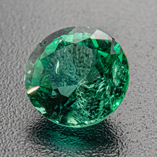 Emerald from Zambia. 0.51 Carat. Round, distinct inclusions