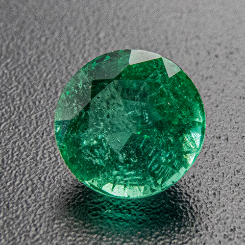 Emerald from Zambia. 0.54 Carat. Round, distinct inclusions