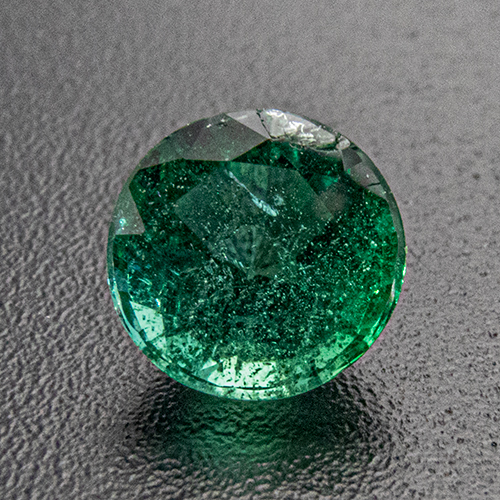 Emerald from Zambia. 0.56 Carat. Round, distinct inclusions