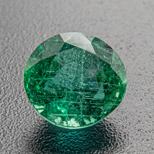Emerald from Zambia. 0.57 Carat. Round, distinct inclusions