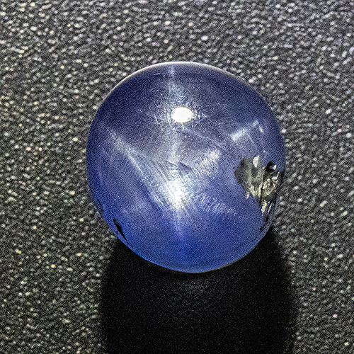 Star Sapphire from Sri Lanka. 3.86 Carat. Very good star + colour. This gem would easily fetch double price or more, if it were not for that inclusion...
Note: the very deep pavilion must not be recut to maintain the high quality of the star.